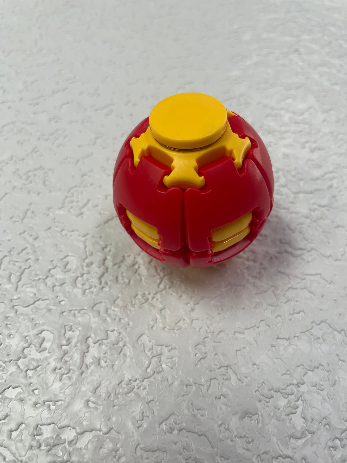 PRESS TO SPIN FIDGET BALL RED YELLOW
