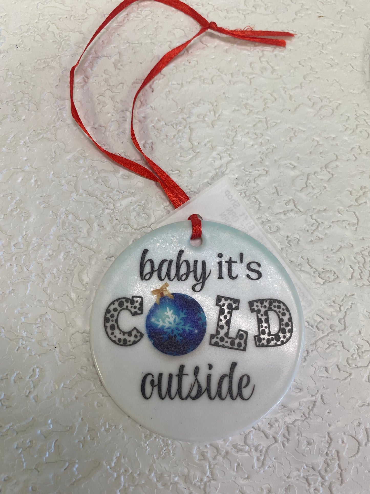 BABY ITS COLD GLASS ORN