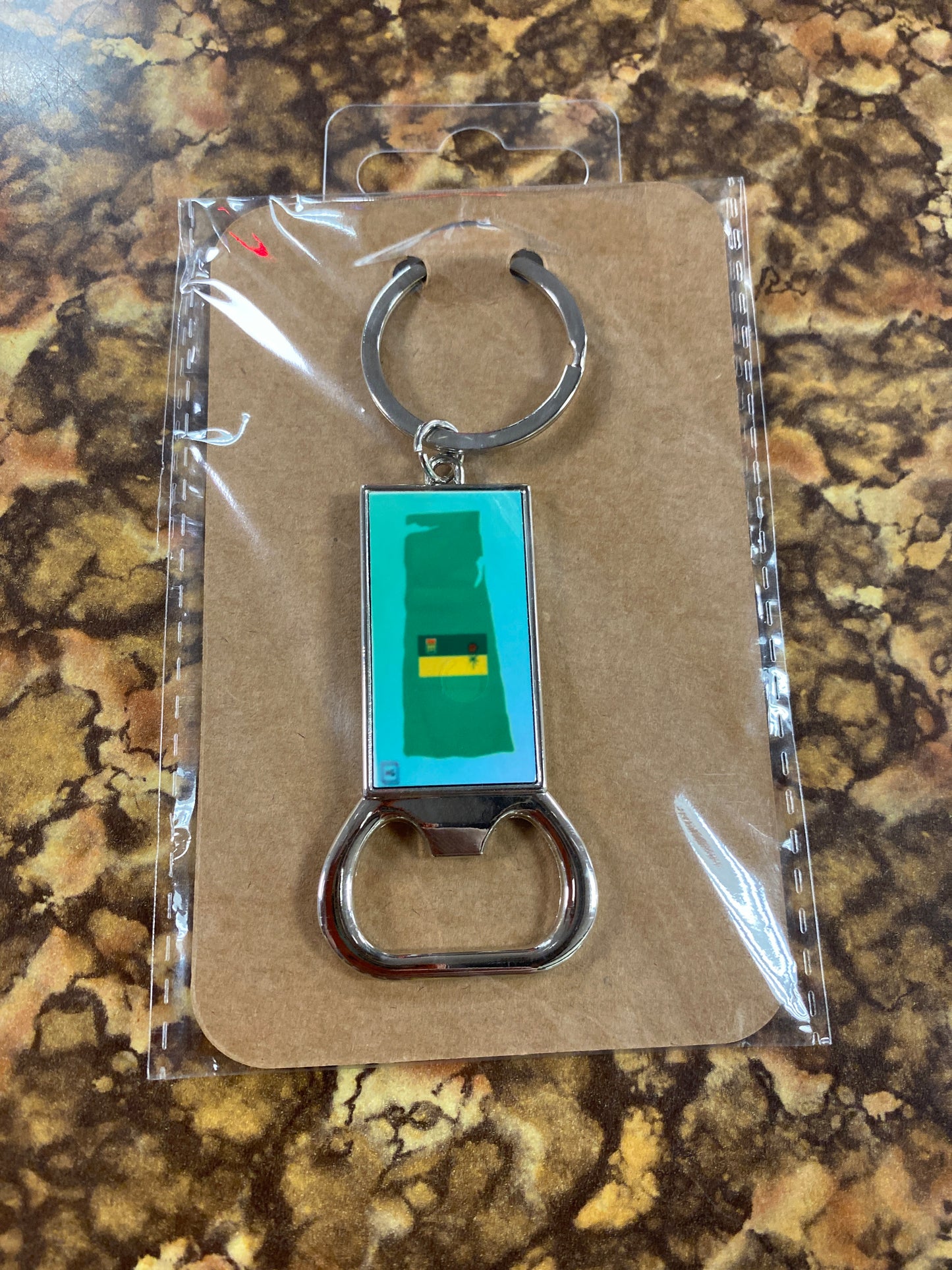 SASK OUTLINE WITH FLAG KEYCHAIN WITH BOTTLE OPENER